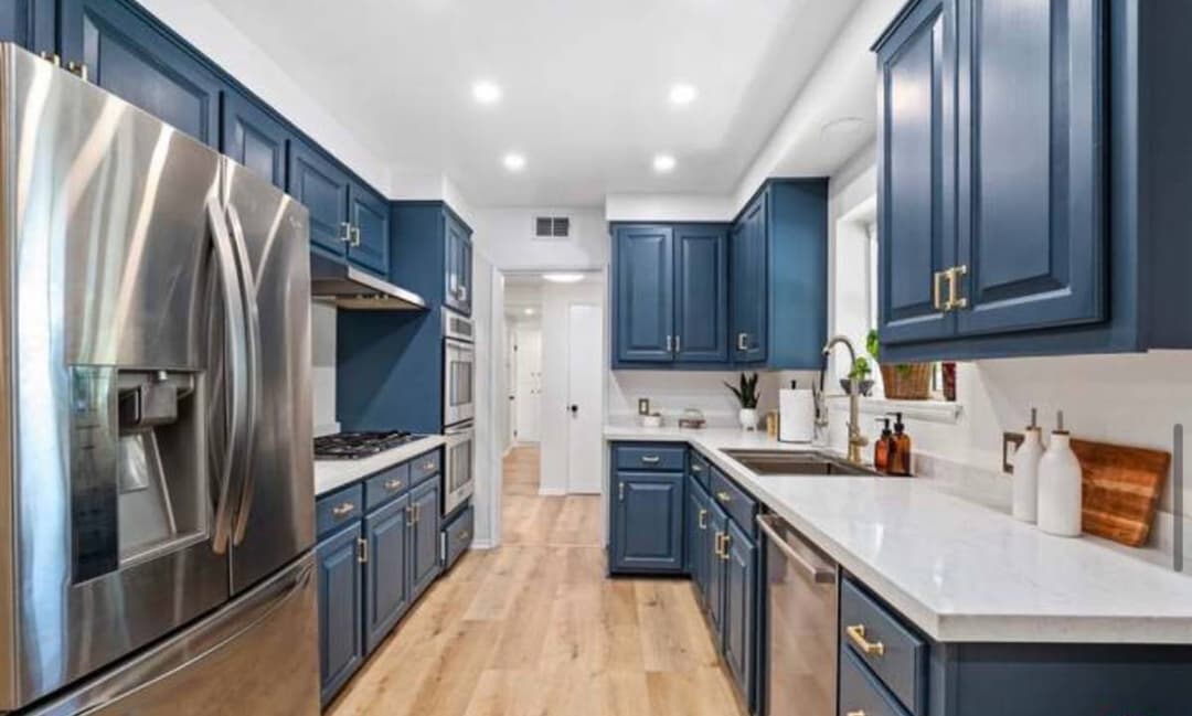 picture of remodeled and designed kitchen with new wood floors, cabinets, and counterstops